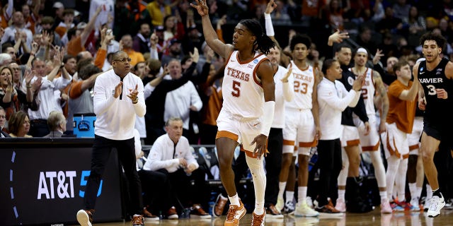 Marcus Carr, #5 of the Texas Longhorns, reacts after scoring a three-point basket against the Xavier Musketeers during the second half in the Sweet 16 round of the NCAA Men's Basketball Tournament at T-Mobile Center on March 24, 2023, in Kansas City, Missouri.