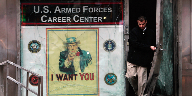 A New York City official walks out of a U.S. military recruiting station in Times Square following the March 6, 2008 attack.