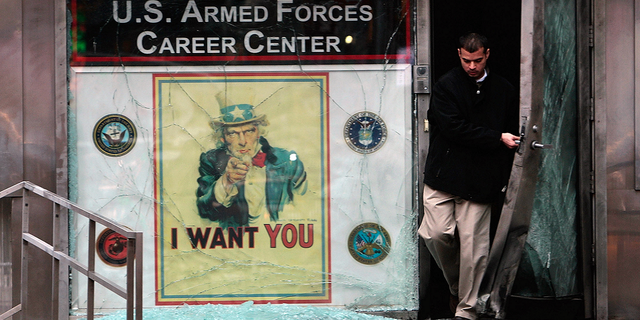 A New York City official walks out of a U.S. military recruiting station in Times Square following the March 6, 2008 attack.