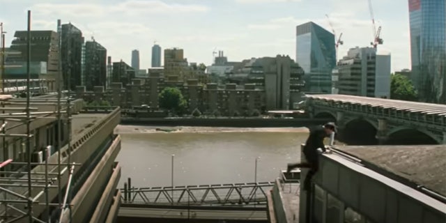 Tom Cruise jumping from a building in a stunt for Mission Impossible: Fallout