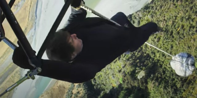 Tom Cruise hanging on a rope attatched to a flying helicopter for a stunt in Mission Impossible: Fallout