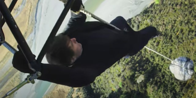 Tom Cruise hanging on a rope attatched to a flying helicopter for a stunt in Mission Impossible: Fallout