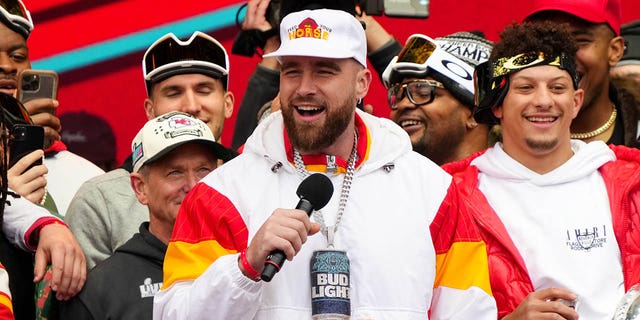 Travis Kelce #87 and Patrick Mahomes #15 of the Kansas City Chiefs celebrate on stage during the Kansas City Chiefs Super Bowl LVII victory parade on February 15, 2023 in Kansas City, Missouri.