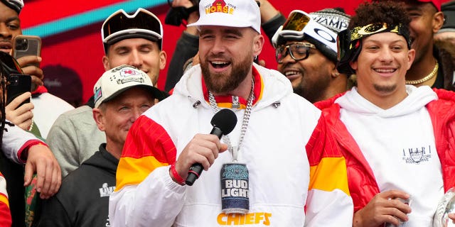 Travis Kelce #87 and Patrick Mahomes #15 of the Kansas City Chiefs celebrate onstage during the Kansas City Chiefs Super Bowl LVII Victory Parade on February 15, 2023 in Kansas City, Missouri.