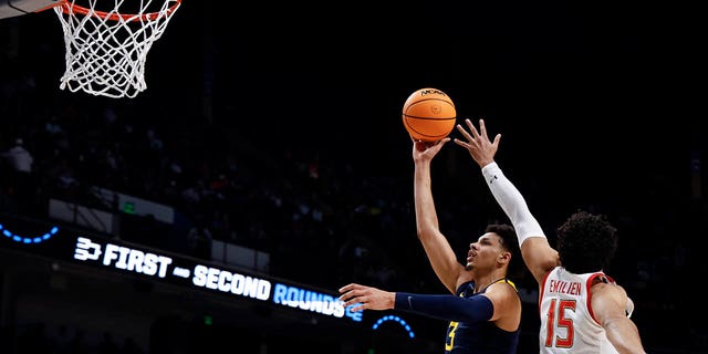 West Virginia forward Tre Mitchell (3) takes a shot as Maryland forward Patrick Emilien (15) defends in the first half of a first-round college basketball game in the NCAA Tournament in Birmingham, Alabama, on Thursday March 16, 2023. 
