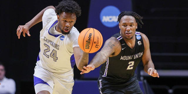 Trey Barber of Captains and Collen Gurley of Purple Raiders chase down a loose ball during the Division III Championship on March 18, 2023, in Fort Wayne, Indiana.