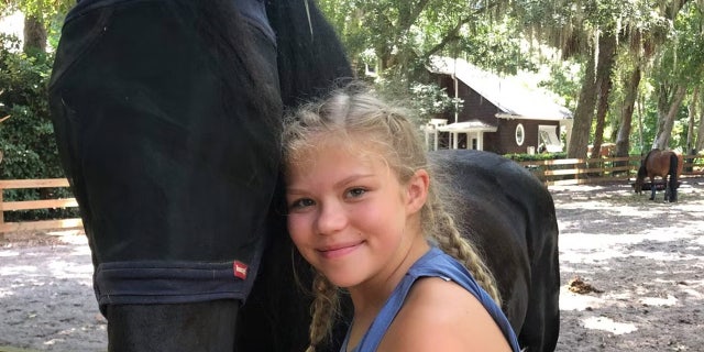 Tristyn Bailey with a black horse. She was fatally stabbed by classmate Aiden Fucci May 9, 2021, in Florida.