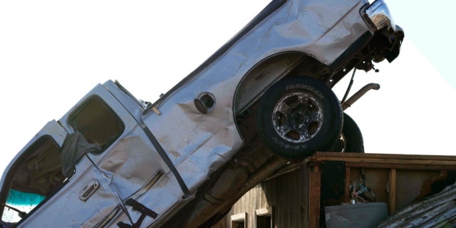 Wind-tossed vehicles, are piled onto another in Rolling Fork, Miss., Saturday, March 25, 2023, the day after a series of storms produced tornadoes moved through the area.  Emergency officials in Mississippi say several people have been killed by tornadoes that tore through the state on Friday night, destroying buildings and knocking out power as severe weather produced hail the size of golf balls moved through several southern states.  