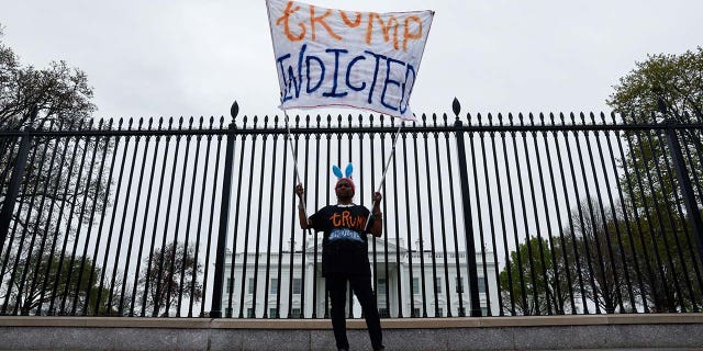 Nadine Seiler holds a "Trump Indicted" sign in front of the White House after former U.S. President Donald Trump's indictment by a Manhattan grand jury following a probe into hush money paid to porn star Stormy Daniels, in Washington, U.S. March 31, 2023.