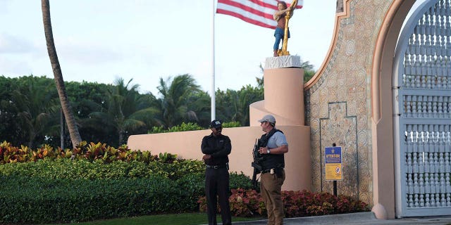 A Secret Service agent and a security guard officer guard the Mar-a-Lago home of former U.S. President Donald Trump