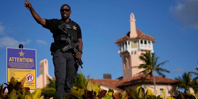 A Secret Service agent told the passerby to keep moving, as he watched over the wall surrounding former President Trump's Mar-a-Lago.