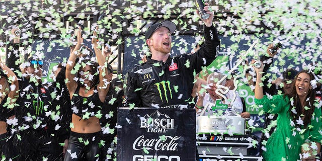 Tyler Reddick, center, celebrates after winning a NASCAR Cup Series auto race at Circuit of the Americas, Sunday, March 26, 2023, in Austin, Texas. 
