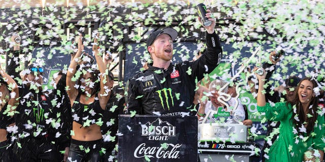 Tyler Reddick, center, celebrates after winning a NASCAR Cup Series auto race at Circuit of the Americas, Sunday, March 26, 2023, in Austin, Texas.