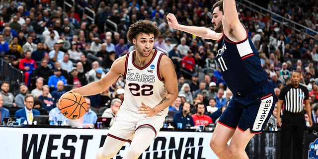 Anton Watson (22) of the Gonzaga Bulldogs handles the ball against Alex Karaban (11) of the Connecticut Huskies during the Elite Eight of the 2023 NCAA Tournament at T-Mobile Arena on March 25, 2023 in Las Vegas.