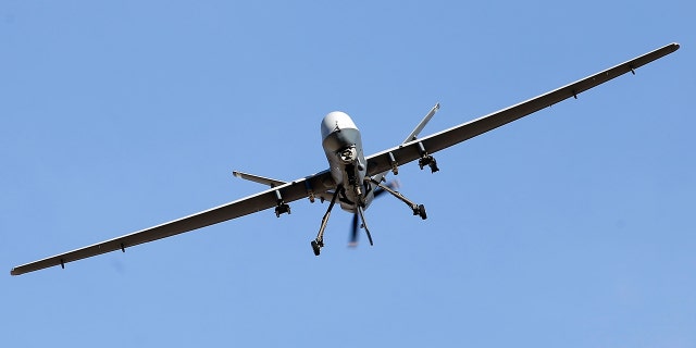 An MQ-9 Reaper remotely piloted aircraft flies by during a training mission at Creech Air Force Base on Nov. 17, 2015, in Indian Springs, Nevada.