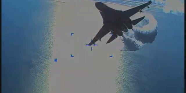 U.S. European Command on Thursday released video of a Russian Su-27 fighter jet colliding with a U.S. MQ-9 Reaper drone over the Black Sea, March 14. A screenshot shows a jet dumping fuel.