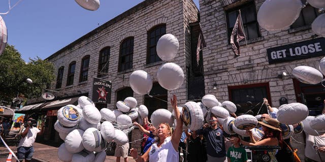 Family members, friends and Austin community members release balloons in memory of Doug Kantor in downtown Austin, Texas, on June 12, 2022.