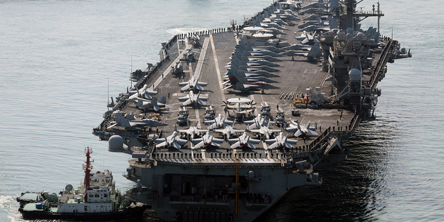 Aircraft carrier USS Nimitz approaches a naval base in Busan, South Korea, on Tuesday, March 28, 2023.