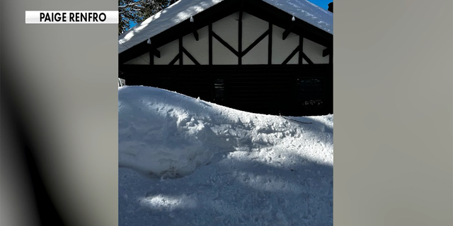 About eight feet of snow surrounded Paige Renfro's Crestline, California, home after a rare blizzard on Feb. 24, 2023. About three feet of snow remained three weeks later.