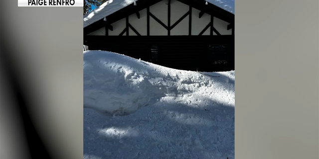 About eight feet of snow surrounded Paige Renfro's Crestline, California, home after a rare blizzard on Feb. 24, 2023. About three feet of snow remained three weeks later.