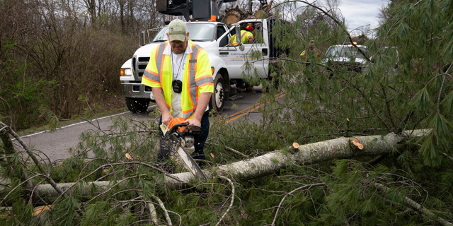 Kevin Bailey of Nashville Department of Transportation uses his chainsaw to cut a tree that is blocking George E. Horn Rd. as severe weather and strong winds blew through Nashville, Tenn Friday, March 3, 2023.