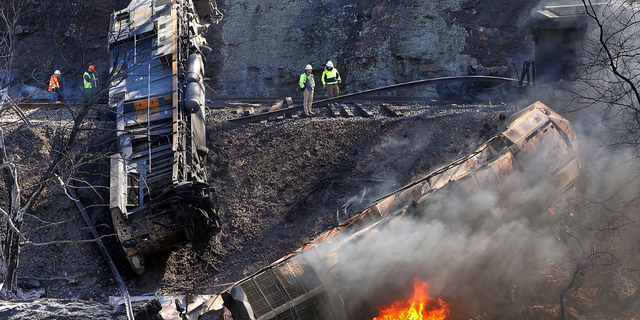 Smoke fills the sky after an empty CSX coal train hit a rockslide along tracks causing a fiery derailment on Wednesday, March 8, 2023 in a remote area just south of Sandstone, W.Va. Four locomotives and 22 empty cars derailed in Summers County near the New River, CSX said. The lead locomotive, which carried a conductor, an engineer and an engineer trainee, caught fire and the crewmembers were being evaluated and treated for non-life threatening injuries, the company said.