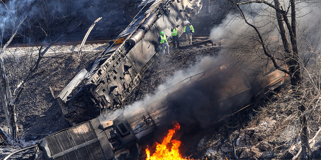 Smoke fills the sky after an empty CSX coal train hit a rockslide along tracks causing a fiery derailment, Wednesday, March 8, 2023, in a remote area just south of Sandstone, W.Va. Four locomotives and 22 empty cars derailed in Summers County near the New River, CSX said. The lead locomotive, which carried a conductor, an engineer and an engineer trainee, caught fire and the crewmembers were being evaluated and treated for non-life threatening injuries, the company said.