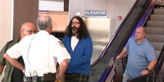 A New Jersey man, center, accused of threatening Volusia County Sheriff Mike Chitwood was extradited and flown to Orlando, where Sheriff Chitwood was there to meet him.