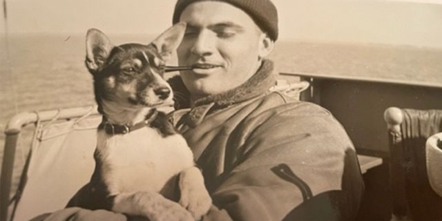 Al Sitarksi pictured holding a dog while at sea sometime in the 1940s.