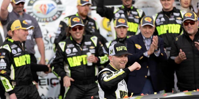William Byrne (24) celebrates with his team after winning a NASCAR Cup Series auto race Sunday, March 5, 2023, in Las Vegas. 