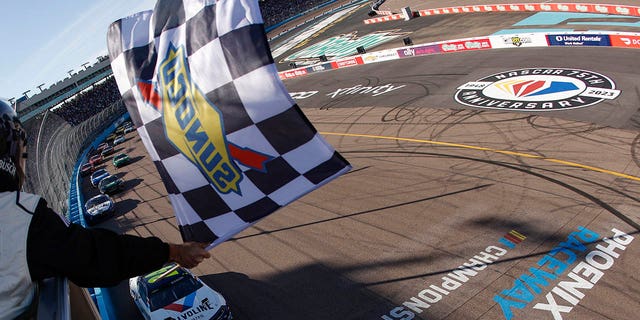 William Byron, driver of the #24 Valvoline Chevrolet, takes the checkered flag to win the NASCAR Cup Series United Rentals Work United 500 at Phoenix Raceway on March 12, 2023 in Avondale, Arizona.