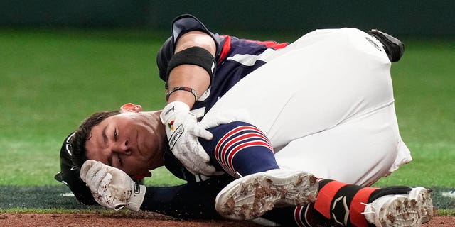 William Escala of Czech Republic reacts after he was hit by pitcher Roki Sasaki of Japan while batting during their Pool B game at the World Baseball Classic at the Tokyo Dome, Japan, Saturday, March 11, 2023. 