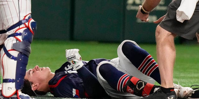 William Escala of Czech Republic reacts after he was hit by pitcher Roki Sasaki of Japan while batting during their Pool B game at the World Baseball Classic at the Tokyo Dome, Japan, Saturday, March 11, 2023. 