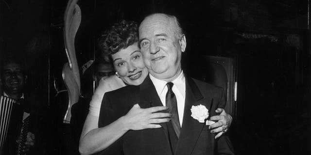 On Dec. 16, 1953, Lucille Ball (1911-1989) hugs William Frawley (1887-1966) as she stands behind him during the surprise party for her 13th wedding anniversary to Cuban-born actor and singer Desi Arnaz, held at Larry Finley's restaurant on Sunset Strip in Los Angeles. Ball, Frawley and Arnaz were costars in the hit TV series "I Love Lucy."