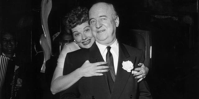 On Dec. 16, 1953, Lucille Ball (1911-1989) hugs William Frawley (1887-1966) as she stands behind him during the surprise party for her 13th wedding anniversary to Cuban-born actor and singer Desi Arnaz, held at Larry Finley's restaurant on Sunset Strip in Los Angeles. Ball, Frawley and Arnaz were costars in the hit TV series "I Love Lucy."