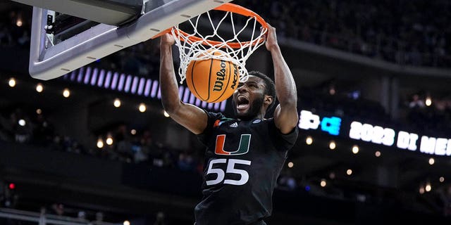 March 26, 2023;  Kansas City, MO, USA;  Miami Hurricanes guard Wooga Poplar (55) yells as he dunks the ball against the Texas Longhorns in the second half at the T-Mobile Center.