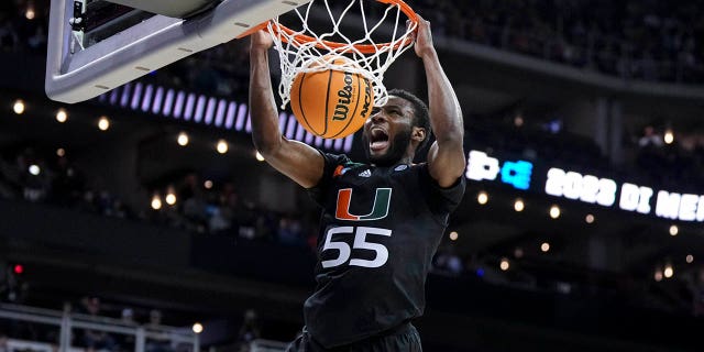 March 26, 2023;  Kansas City, MO, USA;  Miami Hurricanes guard Wooga Poplar (55) yells as he dunks the ball against the Texas Longhorns in the second half at the T-Mobile Center.