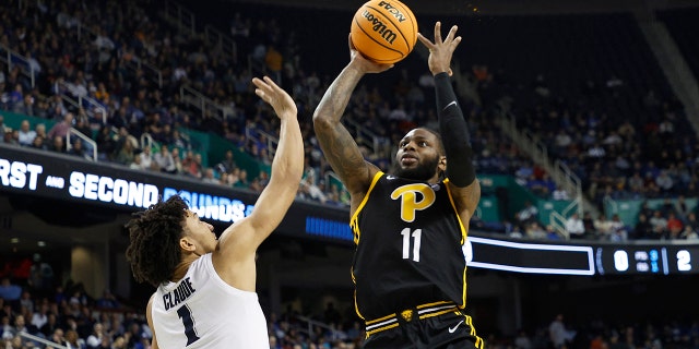 Jamarius Burton #11 of the Pittsburgh Panthers shoots against Desmond Claude #1 of the Xavier Musketeers during the second half of the second round of the NCAA Men's Basketball Tournament at Fieldhouse at Greensboro Coliseum on March 19, 2023 in Greensboro, North Carolina .