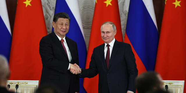 Russian President Vladimir Putin and Chinese President Xi Jinping shake hands in Moscow, Russia, on Tuesday, March 21. 