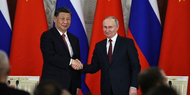 Russian President Vladimir Putin and Chinese President Xi Jinping shake hands in Moscow, Russia, on Tuesday, March 21. 