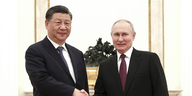 President Vladimir Putin and Chinese President Xi Jinping shake hands before a meeting at the Kremlin in Moscow, Russia, on Monday, March 20.
