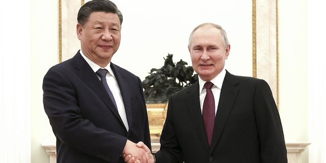 Russian leader Vladimir Putin and Chinese President Xi Jinping shake hands before a meeting at the Kremlin in Moscow on March 20, 2023.