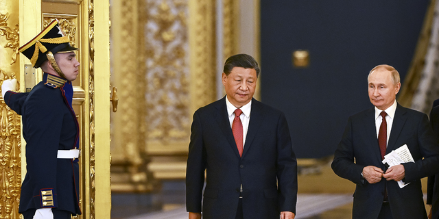 The announcement about the Abrams tanks heading to Ukraine comes as Chinese President Xi Jinping, center, and Russian President Vladimir Putin, right, are having a second day of meetings in Moscow.