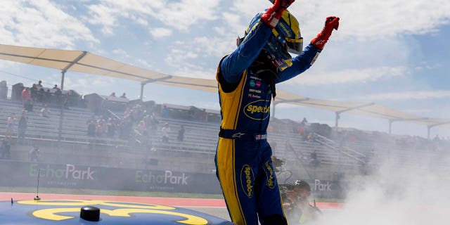 Zane Smith hops out of his truck after winning a NASCAR Truck Series auto race at Circuit of the Americas, Saturday, March 25, 2023, in Austin, Texas.