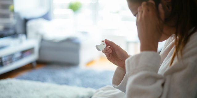Woman with pregnancy test