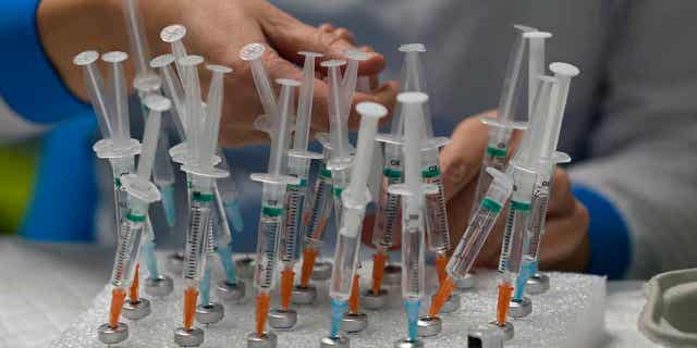 A nurse prepares COVID vaccines in the Wizink Center in Madrid, Spain on December 1, 2021. Forty-two families in the Spanish Basque Country are pursuing a lawsuit against a nurse who allegedly falsified the process of administering the vaccines to their children .