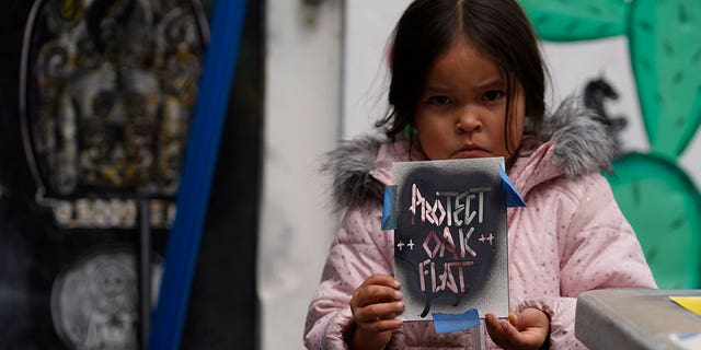 Apache Stronghold personnel Raetana Manny, 4, shows a motion to prevention Oak Flat, a tract eastbound of Phoenix that nan group considers sacred, successful Los Angeles connected March 20, 2023. 