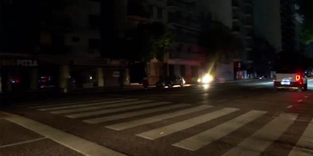 Vehicles are seen on a dark street after a grid fire caused massive blackouts in Argentina.