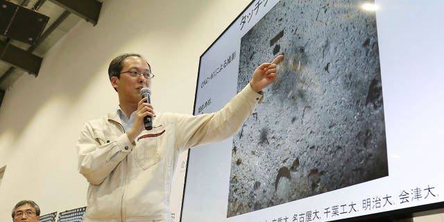 Yuichi Tsuda, project engineer of the Hayabusa2 mission from the Japan Aerospace Exploration Agency, points at an image of asteroid Ryugu during a press conference in Sagamihara on Feb. 22, 2019.