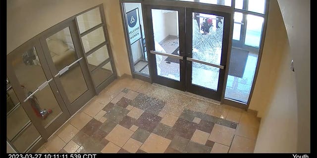 Covenant school shooter Audrey Hale is seen in surveillance footage climbing through the school's glass doors after shooting through them (0:48).